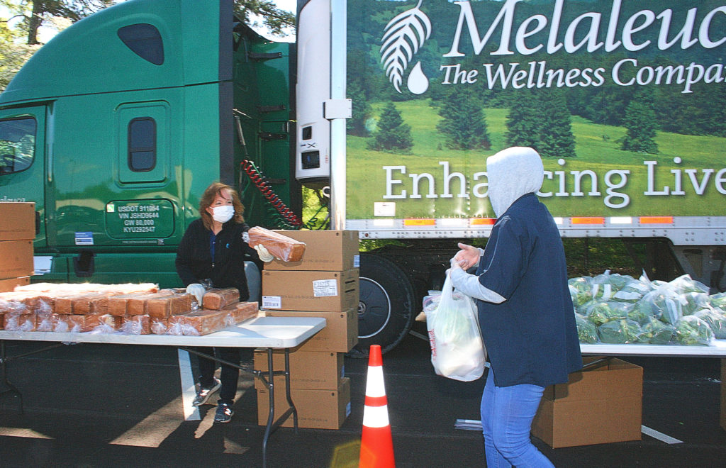 Melaleuca employee giving food to fellow Melaleuca employee outside