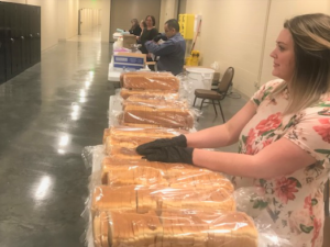 Melaleuca employee distributing bread