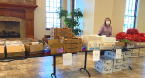 a women handing out donated food in the Melaleuca Global Headquarters