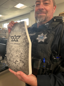 Deputy holding plate that slips inside a Kevlar pouch.