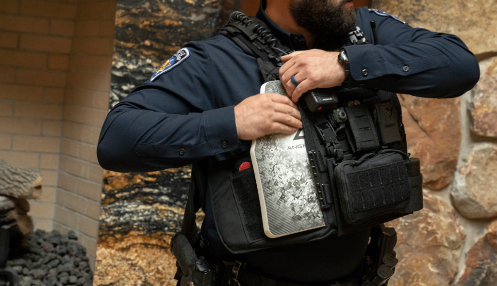 IFPD officer placing plate in Bulletproof vest