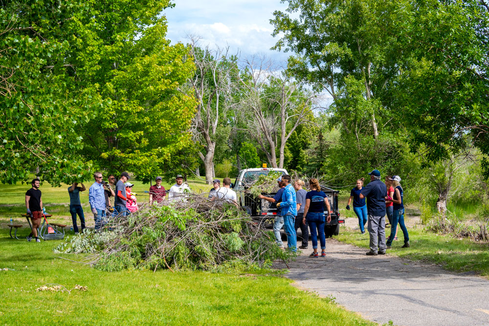 Melaleuca Employees clear out debris from local river walk