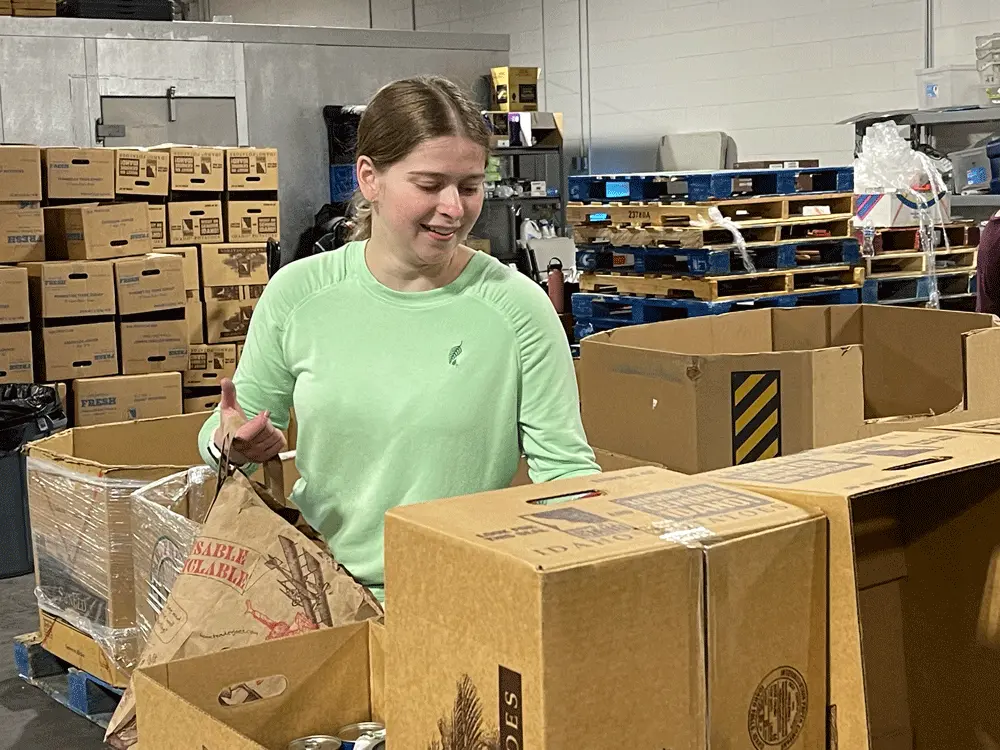Melaleuca Employee volunteering to sort food