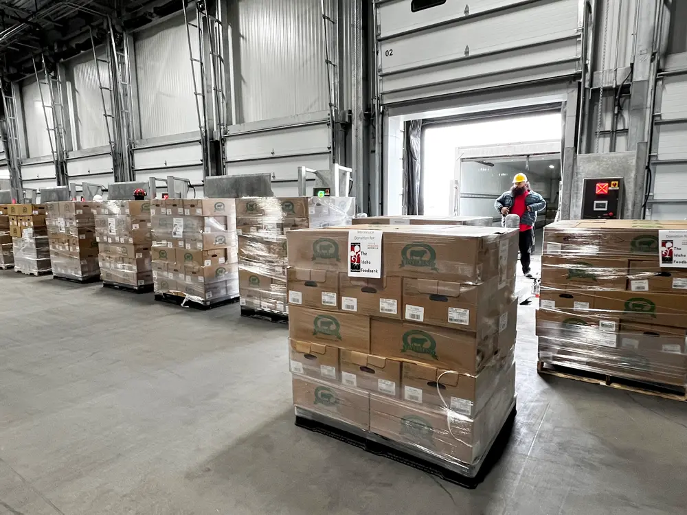 worker unloads melaleuca beef donation with electric pallet jack